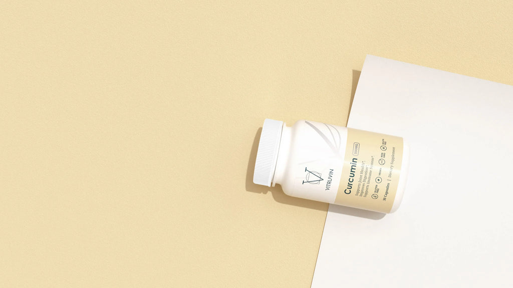 Top view of a Curcumin supplement bottle laid out on a beige background